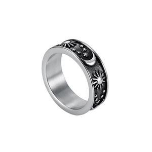 Retro stainless steel ring with embossed sun, moon and stars celestial pattern on white background