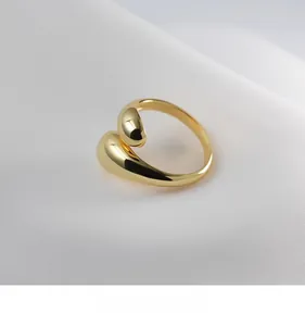 Detailed macro view of 18K gold bean ring with fluid curves and polished surface