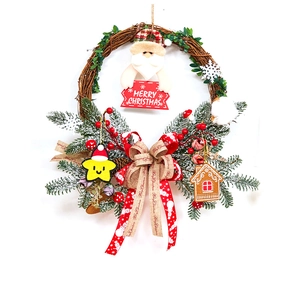 Christmas rattan wreath with Santa doll and Merry Christmas sign for festive door decoration