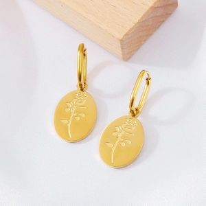 Detailed close-up of gold stainless steel oval earrings with embossed rose flower design