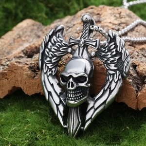 Macro view of Gothic skull wing sword pendant on natural moss and wood background