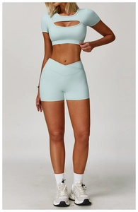 Detail of mint green yoga set featuring hollow-out top and cross-waist gym shorts