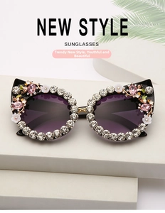 Close-up of luxury cat-eye sunglasses with gradient purple lenses and rhinestone decor