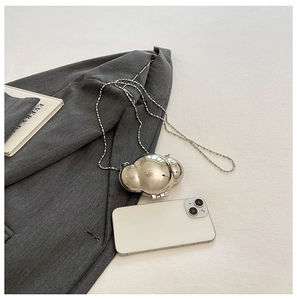 Chic silver mini metal shell bag with glossy mirror finish and delicate bead chain strap