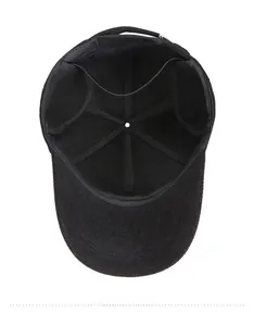 Detail view of the thick warm lining and ear protection on the black winter baseball cap