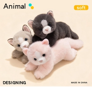 Detailed view of three soft plush Persian cat toys in grey black and pink colors
