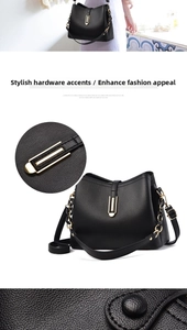 Detailed view of black lychee leather handbag with gold buckle and metal chain strap