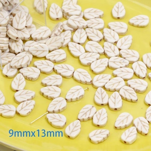 Macro view of 9x13mm leaf-shaped white turquoise beads with natural stone texture