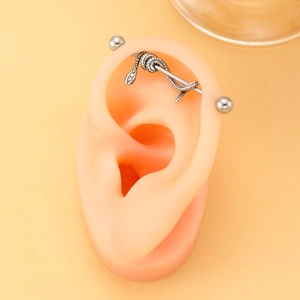 Vintage silver snake industrial barbell piercing jewelry on a silicone ear model