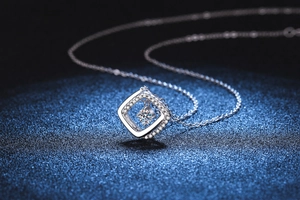 Macro shot of 925 silver necklace with square hollow pendant and brilliant moissanite stone