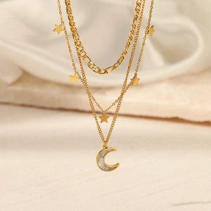 Three-layer gold stainless steel necklace with star and crescent moon pendants on silk
