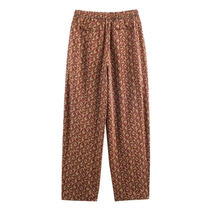 Detail of paisley print pants with elastic waist and red-brown floral pattern