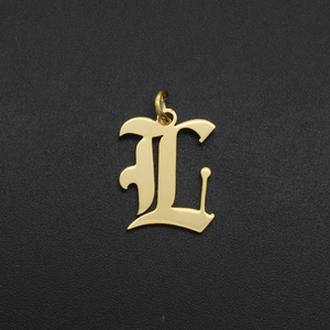Detailed close-up of a golden gothic letter L pendant with a polished metal finish