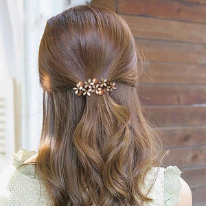 Floral beaded metal spring clip for half-up hair styles shown on a female model