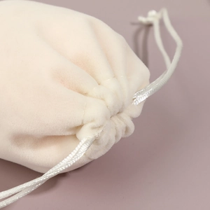 Thick velvet drawstring jewelry pouch in cream beige for storage and gifts