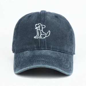 Detail of cartoon dog embroidery on navy blue washed denim baseball cap with curved brim