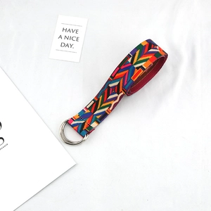 Detailed view of canvas belt featuring ethnic geometric patterns and silver double D-rings