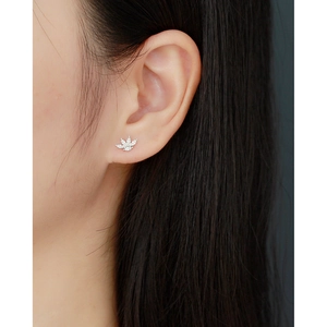 Close-up of a s925 silver maple leaf stud earring with cubic zirconia on a model