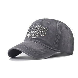 Close-up of Paris 3D embroidery on washed cotton fabric of a dark grey baseball cap