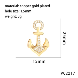 Macro shot of gold-plated anchor pendant with zircon inlay and detailed size markers