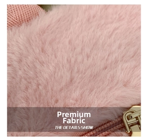 Detail of pink faux fur texture and golden metal zipper on cute lamb wool backpack