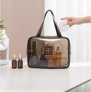 Macro detail of transparent waterproof makeup bag being packed with cosmetics