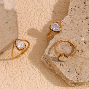 Detailed view of 18K gold plated stainless steel rings with teardrop white zircon stones