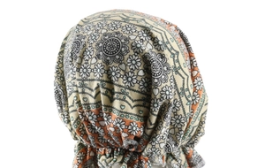 Detail view of pre-tied turban headwrap with black floral and blue heart print patterns