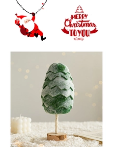 Detail of wool felt Christmas tree with wooden base on warm blurred background