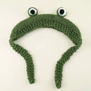Handmade crochet green frog headband with large 3D eyes for warmth and costume styling