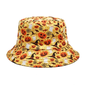 Detail of yellow Halloween bucket hat with pumpkin, ghost and spider web patterns