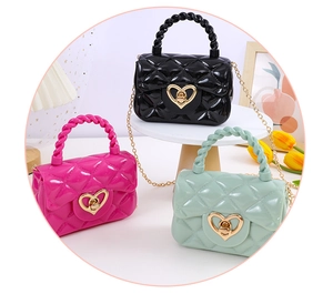 Three jelly mini bags with heart locks, diamond patterns and golden chains on white display