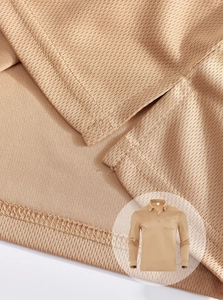 Macro view of breathable khaki fabric texture and stitching on long sleeve polo shirt