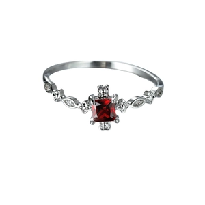 Exquisite silver ring with a square red gemstone and diamond-like accents on a white background