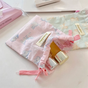 Cute printed drawstring pouches in pink and teal for organizing cosmetics and skincare items