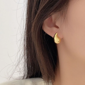 Minimalist 925 sterling silver water drop earrings in golden finish worn by model