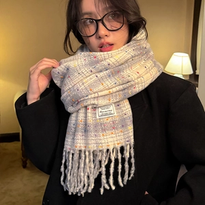 Gray wool scarf with colorful polka dots, plaid pattern and fringe tassels on a model