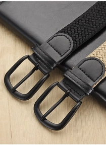 Detail of metal buckle and elastic woven texture on black and beige canvas belts