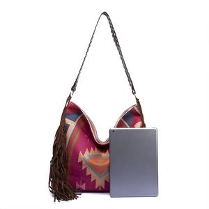Detailed view of bohemian magenta tote bag showing size relative to a tablet