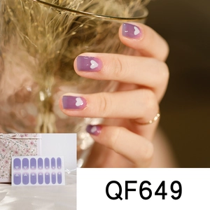 Close-up of purple gradient cow heart nail art stickers showing model hand and packaging