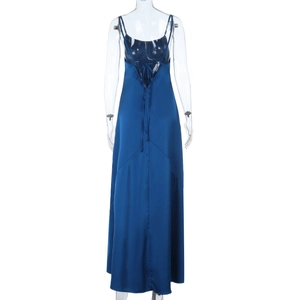 Detail of blue satin long dress featuring backless criss-cross tie-up design on mannequin