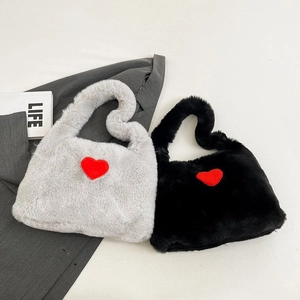 Detailed plush texture of grey and black faux fur handbags with vibrant red heart patches