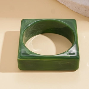 Close-up of square green marble texture acrylic bangle with internal cloud patterns
