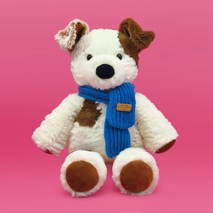 Cute stuffed puppy toy with blue scarf on pink background for nursery decor