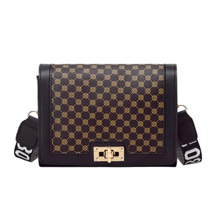 Black leather crossbody bag with vintage monogram pattern and gold twist lock closure