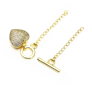 Detailed view of gold plated brass heart charm with micro-pave cubic zirconia and OT toggle clasp