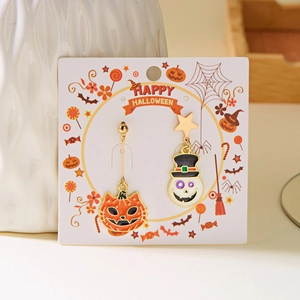 Detail of asymmetric Halloween earrings with pumpkin cat and skull charms on card