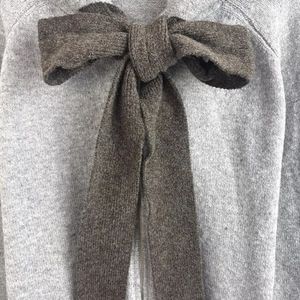 Women's knit hooded jacket in grey and dark brown featuring a large bow detail