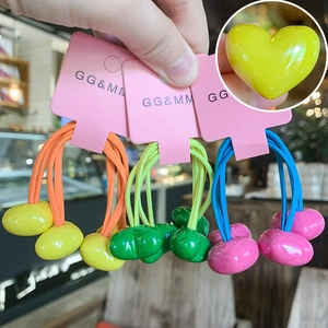 Detail of colorful heart-shaped hair ties with elastic cords and glossy finish