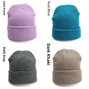 Flat lay of four ribbed knit beanies in lilac, blue, dark grey, and khaki colors